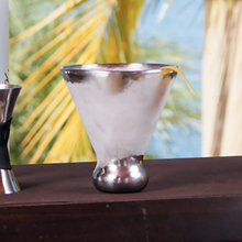 Stainless steel martini glass on an outdoor table