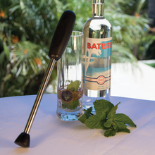 Giovanni muddler beside a mojito with mint and lime