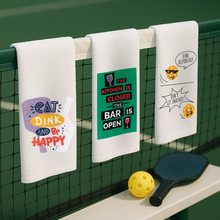 Three printed pickleball bar towels hanging side by side