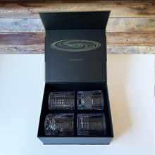 The Whirlwind gift box open, showing four glasses each with a different cut pattern