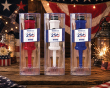 Three 250th Anniversary Cork Pops openers in packaging against festive lights