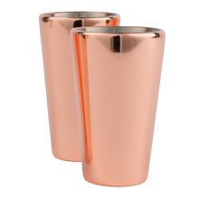 Two copper-finish shot glasses standing side by side