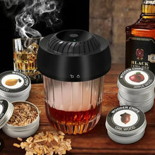Electric cocktail smoker over a glass with tins of wood chips