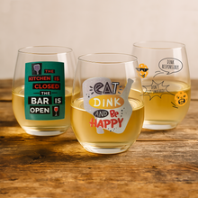 Three printed pickleball wine glasses on a wooden table outdoors