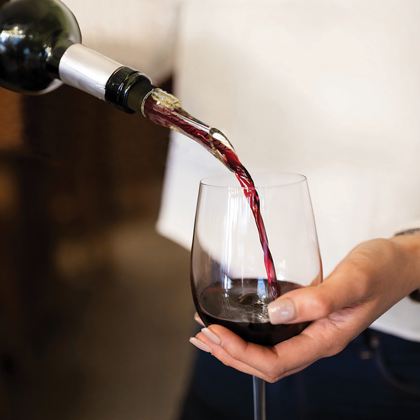 Red wine pouring through a VinOair aerator into a glass