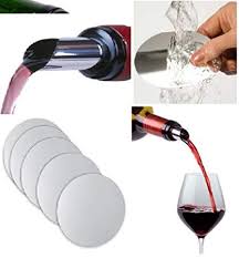 Drop Stop discs shown flat beside a glass of red wine